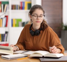 Student preparing for exam at table indoors